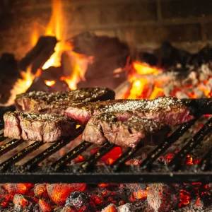 Seasoned Steaks on Charcoal Grill